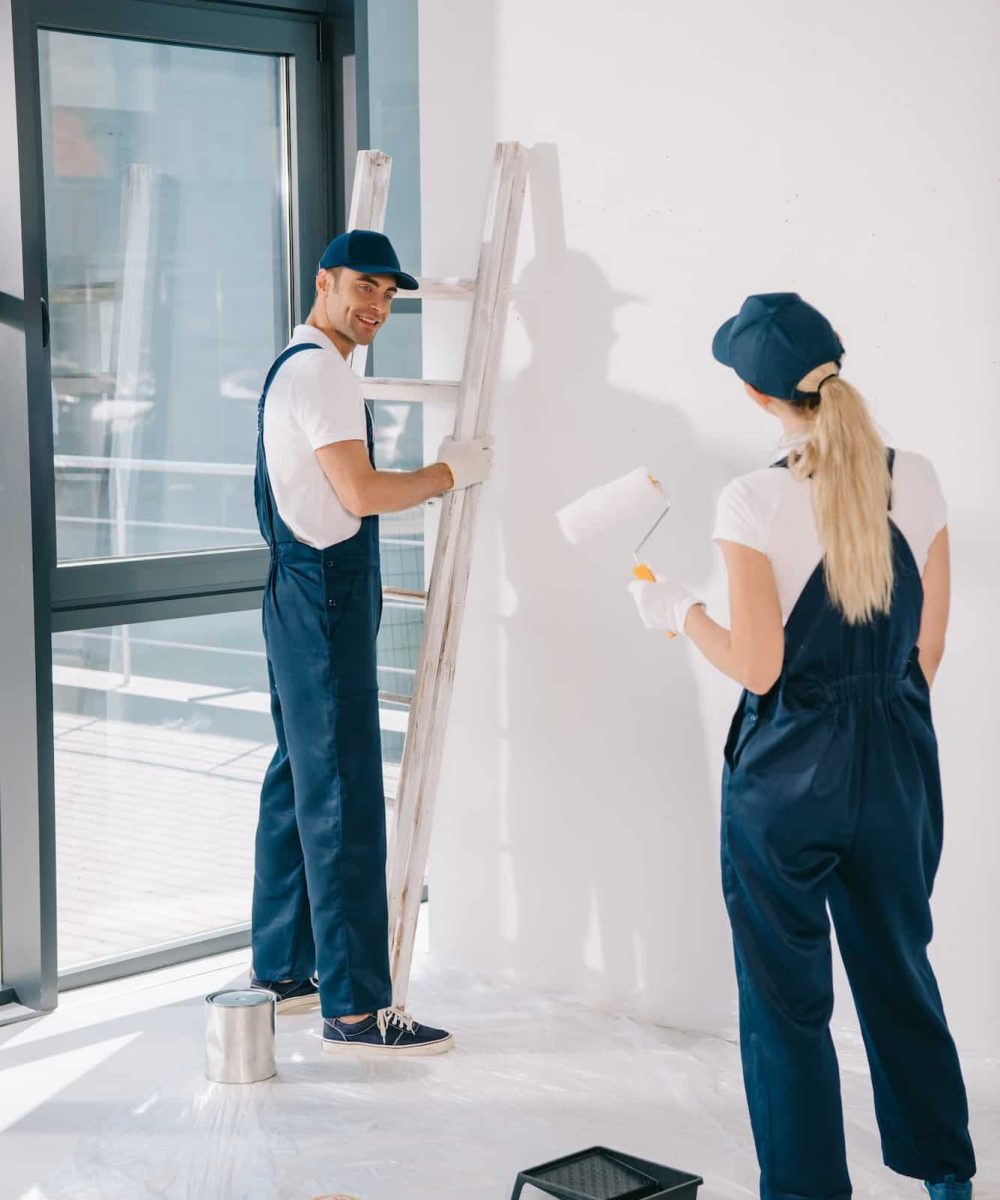 handsome-painter-standing-near-ladder-while-pretty-colleague-holding-paint-roller.jpg